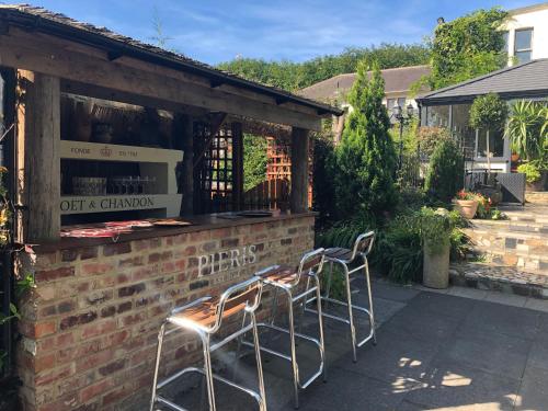 a group of chairs sitting outside of a building at Michelangelos - Rooms, Restaurant & Bar in Gateshead