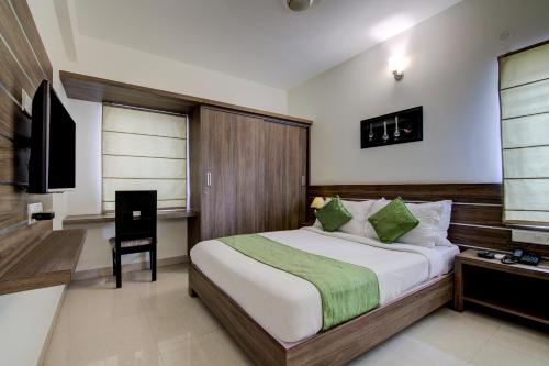 מיטה או מיטות בחדר ב-Sunshine Suites Grand Deluxe