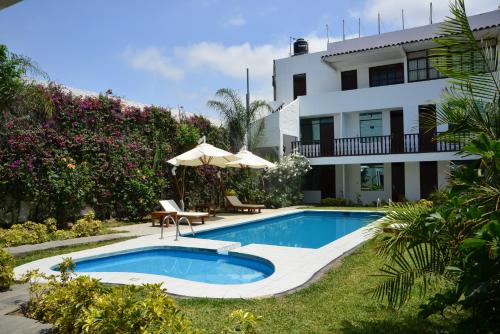 a swimming pool in front of a house at Qallwa Asia in Asia
