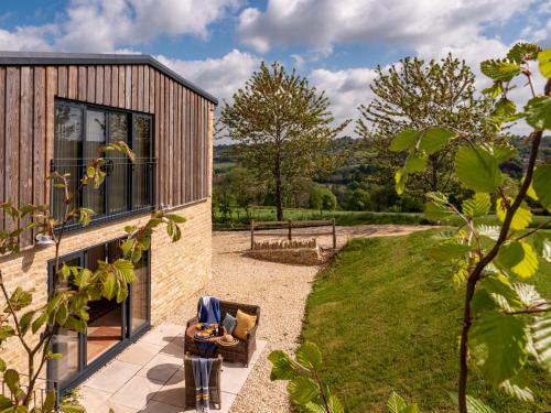 a house with a view of a yard with a building at Vineyard Barn Room in Woodchester