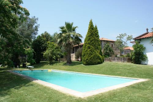 a swimming pool in the yard of a house at Quinta Do Sobreiro in Vila Verde