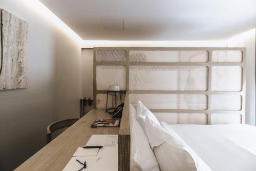 a bedroom with a bed and a wooden table at RYO KAN Ciudad de México in Mexico City