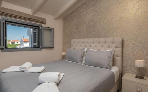 a bedroom with a large bed and a window at Villa Shameti - Private Villa with Pool and Billiards Near Zakynthos Town By Villa Mana Gers in Zakynthos Town