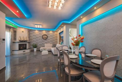 a dining room with a table and chairs and a couch at Villa Shameti - Private Villa with Pool and Billiards Near Zakynthos Town By Villa Mana Gers in Zakynthos Town