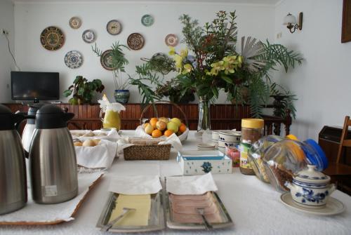 a table with fruits and plates on top of it at Quinta Do Sobreiro in Vila Verde