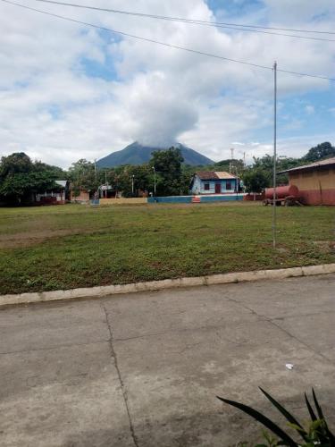 a field of grass with a mountain in the background at Casa Krisdalia in Moyogalpa