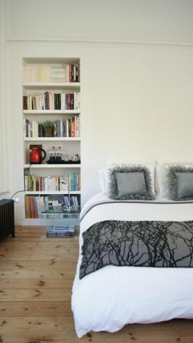 a bedroom with a bed and a book shelf with books at Au Cœur De Lille in Lille