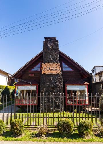 a house with a sign on the front of it at B&B HMüller in Pucón