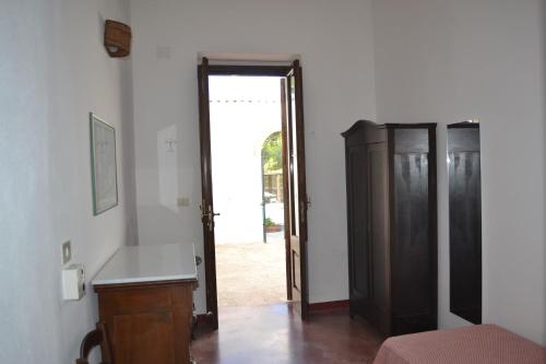 a room with a door open to a bedroom at torre casciani in Ugento