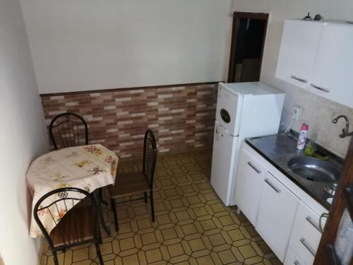 een kleine keuken met een tafel en een wastafel bij centro piria apartamento 1 in Piriápolis