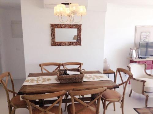 a dining room table with chairs and a mirror at Depto 203 Edificio Bikini Beach, Manantiales in Punta del Este