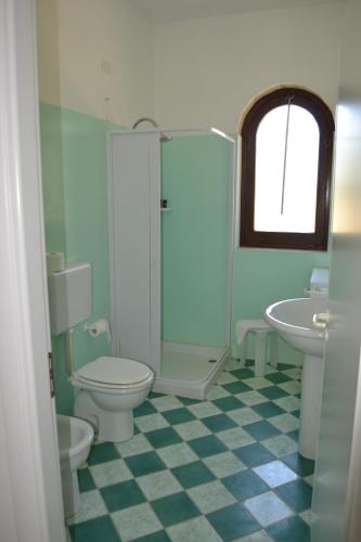 a bathroom with a toilet and a shower and a sink at torre casciani in Ugento