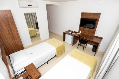 Cama ou camas em um quarto em Hotel Jardins