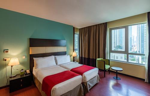 a hotel room with a bed and a large window at Ramada by Wyndham Downtown Dubai in Dubai