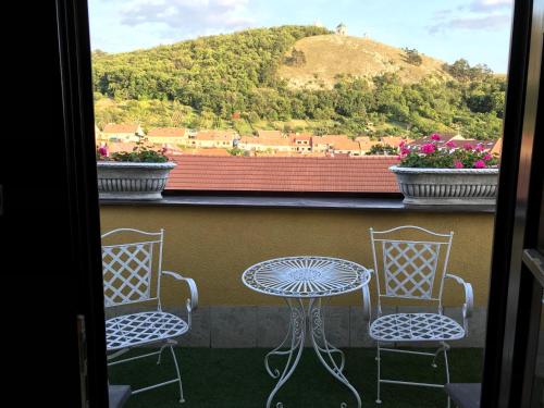 a table and two chairs on a balcony with a view at U svatého Urbana in Mikulov
