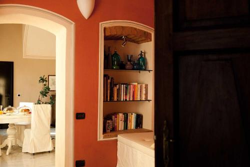 a room with a book shelf with books at Antico Hospitale in Dogliani