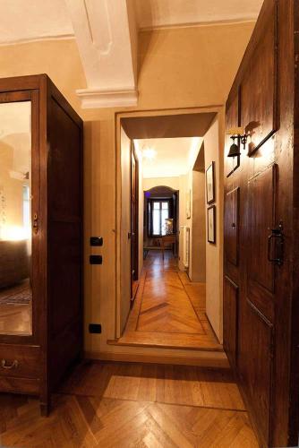 a hallway of a home with wooden floors and an open door at Antico Hospitale in Dogliani