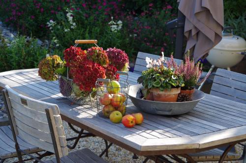 a wooden table with fruits and plants on it at La Grange Neuve in Plougonvelin