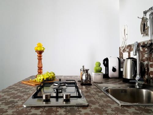 a kitchen counter with a sink and a stove at acquarello in Siracusa