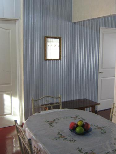 a room with a table with a bowl of fruit on it at Cosy home for short stay or a weekend getaway in Paramaribo