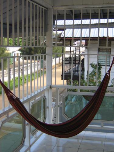 a hammock in the middle of a building at Cosy home for short stay or a weekend getaway in Paramaribo