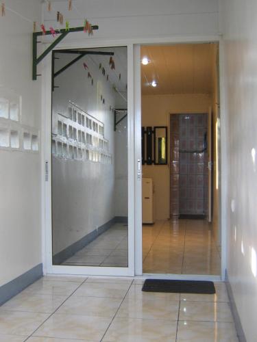 a sliding glass door in a room with a hallway at Cosy home for short stay or a weekend getaway in Paramaribo
