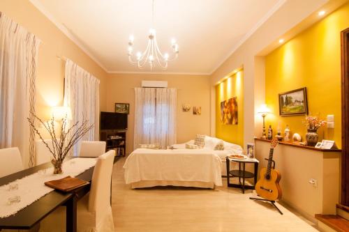 a bedroom with a bed and a guitar in it at Villa Magia in Ýpsos