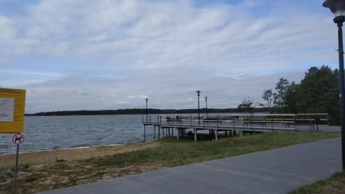 a pier next to a body of water at Villa Helena in Nowe Warpno