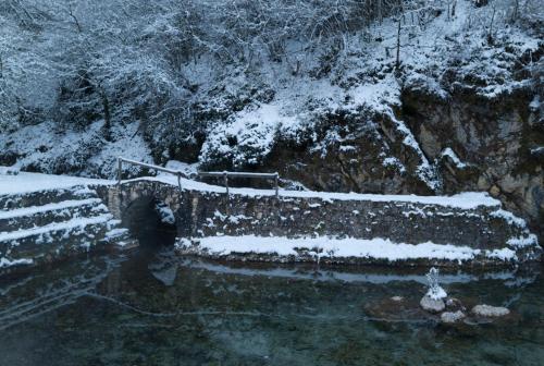 a snow covered mountain with a road and water at Boutique Hotel Palazzo Corso Umberto in Boiano