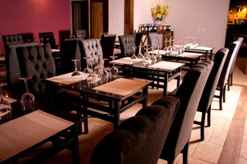 a row of tables and chairs in a restaurant at Hotel Santiurde SOLO ADULTOS in Mineral del Monte