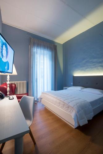 a large bedroom with a large bed and a table at Boutique Hotel Palazzo Corso Umberto in Boiano