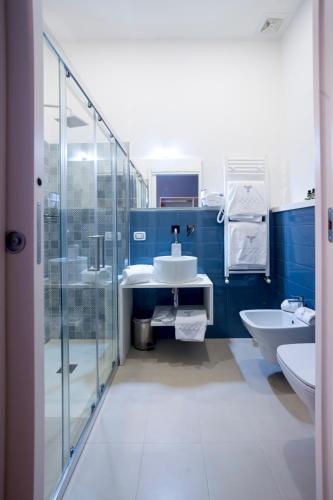 a blue bathroom with a sink and a shower at Boutique Hotel Palazzo Corso Umberto in Boiano