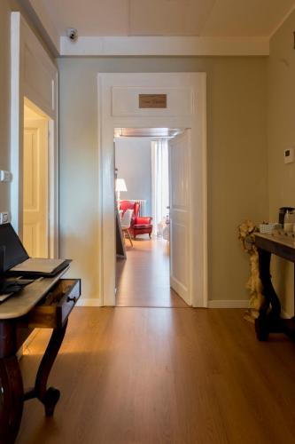 a room with a hallway with a table and a door at Boutique Hotel Palazzo Corso Umberto in Boiano