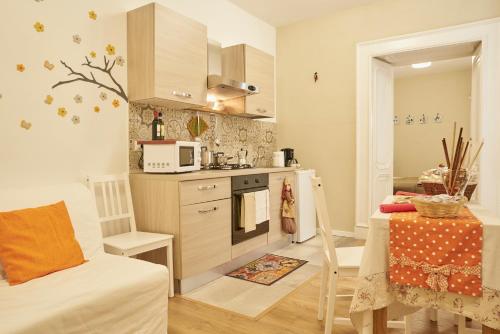 a small kitchen with a table and a microwave at Donna Mariella in Naples