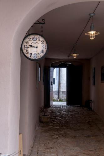 a clock hanging on the side of a hallway at Boutique Hotel Palazzo Corso Umberto in Boiano