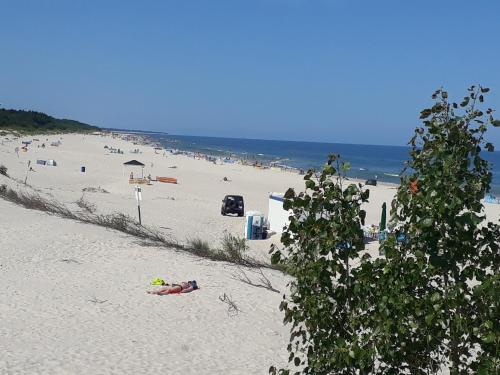 a group of people laying on a beach at Casa del Mare, Apartments and more in Łeba