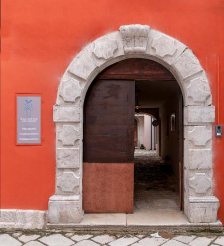 an entrance to a red building with an archway at Boutique Hotel Palazzo Corso Umberto in Boiano