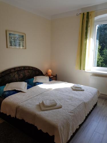 a bedroom with a bed with two towels on it at Agroturystyka u Kasi in Kłodzko