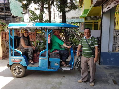 a group of people riding in a golf cart at Bhaskar Homestay in Dibrugarh
