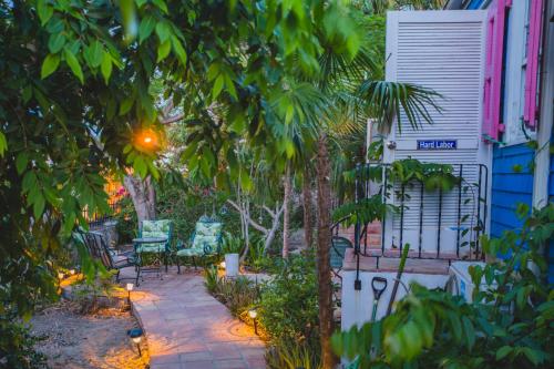 a patio with chairs and a table in a yard at Sugar Apple Bed and Breakfast in Christiansted