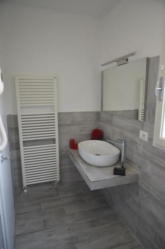 a bathroom with a sink and a mirror at Pisa Apartment Tower in Pisa