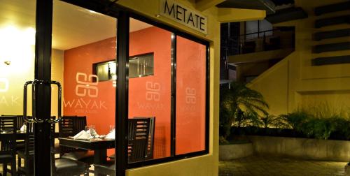 a view of a restaurant with a table through a glass door at Wayak Hotel in Managua