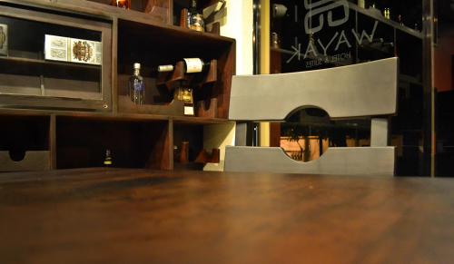 a close up of a wooden table in a bar at Wayak Hotel in Managua