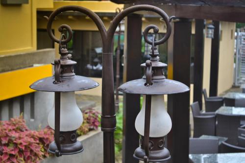 two lights on the side of a fence at Wayak Hotel in Managua