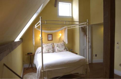 a bedroom with a bed with a metal bed frame at Gedney Farm in New Marlborough