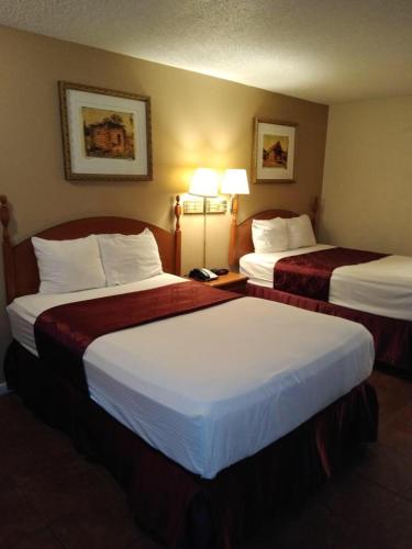 a hotel room with two beds in a room at Knights Inn San Antonio near Frost Bank Center in San Antonio