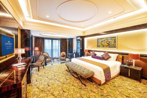 a hotel room with a bed and a living room at Howard Johnson Agile Plaza Chengdu in Chengdu