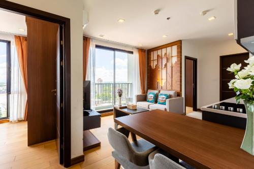 a living room with a dining room table and a couch at Anta Residence ''Self-sevice apartment'' in Chiang Mai