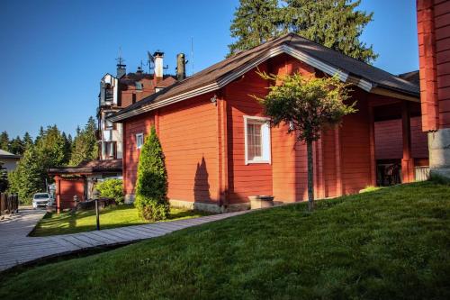 an orange house with a lawn in front of it at Alpin Borovets, Алпин Боровец in Borovets