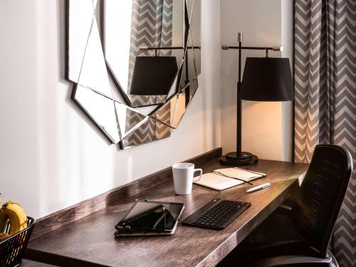 a desk with a keyboard and a laptop on it at Mercure Bridgwater in Bridgwater